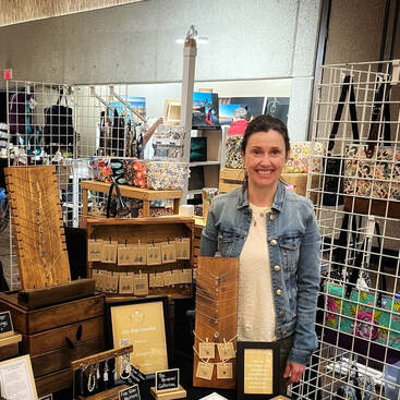 Cheryl from Clay Tulips by C Standing at Her Market Table Artisan Bazaar